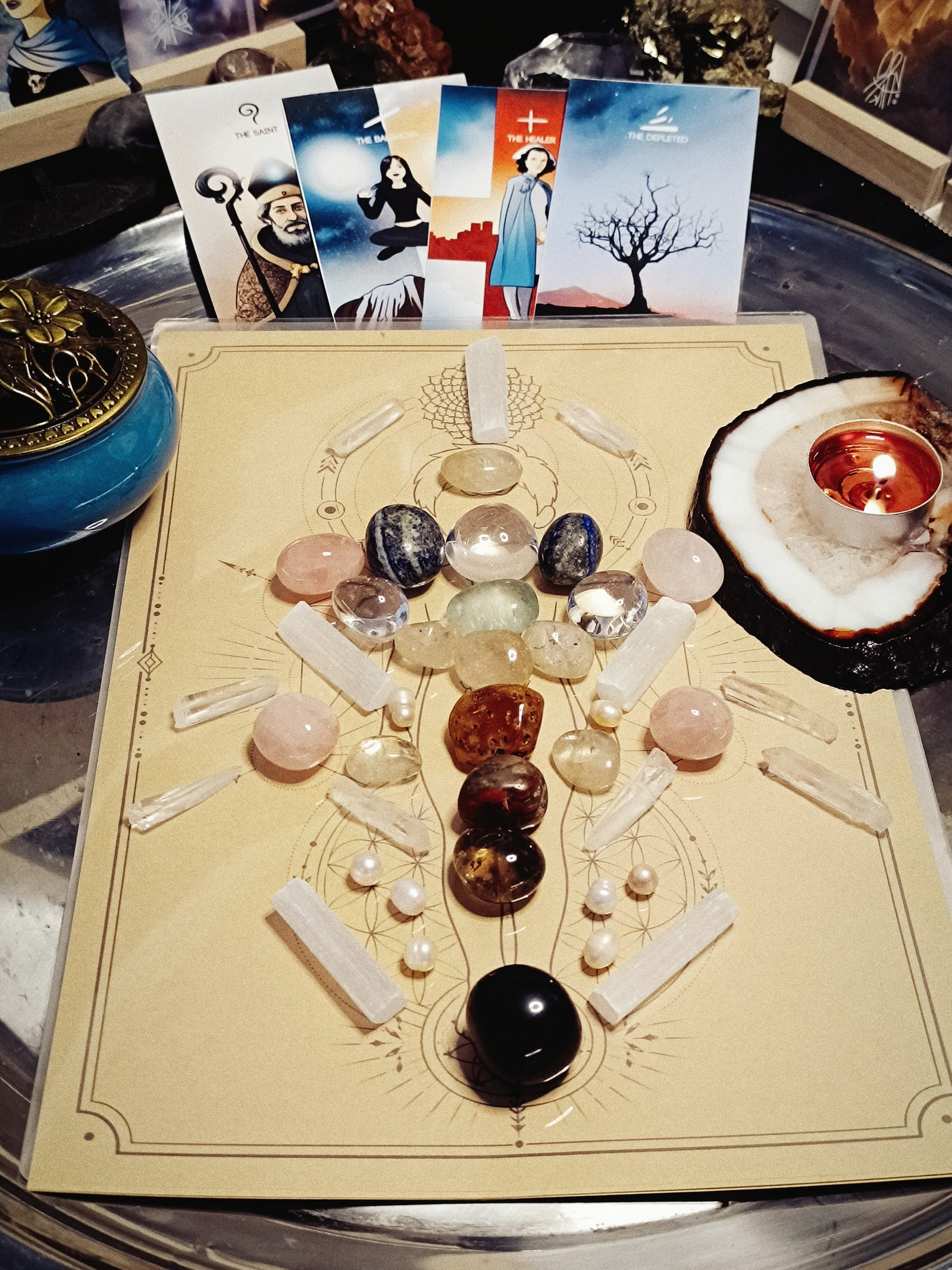 Lucent crystal healing grid arranged with symbolic cards and candlelight