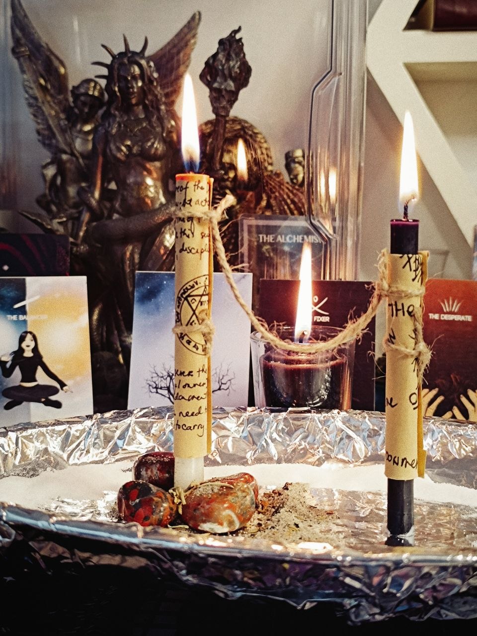 A dressed candle lit before Madame Rberry’s altar